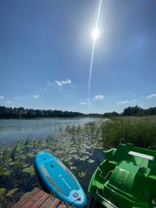 a boat and a canoe on a dock in the water at Przystanek Orle in Gorczyca