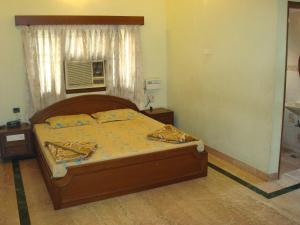 Postel nebo postele na pokoji v ubytování Lloyds Serviced Apartments,Krishna Street,T Nagar