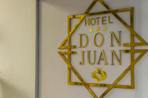 a sign that reads hotel doom jumeirah on a wall at Don Juan in Granada