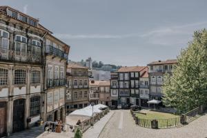 a group of buildings in a city with a street at Trovador Guest House in Guimarães