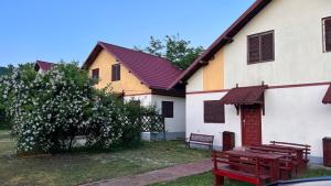 a building with two benches in front of it at Mojo Beach in Budeasa Mare