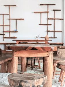 a wooden table in a room with wooden shelves at Dhoadhi Retreat in Thulusdhoo
