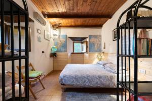 a bedroom with a bed and a wooden ceiling at La casa nel bosco-senza auto in Ponte della Venturina