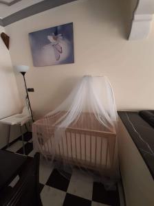 a crib covered in mosquito nets in a bedroom at Al-marsa2 in Al Hoceïma
