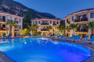 a large swimming pool in front of some buildings at Marcan Beach Hotel in Oludeniz