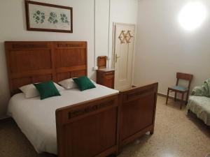 a bedroom with a large bed and a chair at Il Sogno in Foligno
