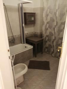 a bathroom with a toilet and a tub and a sink at Il Sogno in Foligno