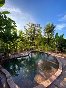 a pool of water with trees in the background at Sítio Monte Alegre in Ibicoara