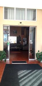 a living room with glass doors and a rug at Hotel Slodes in Belgrade