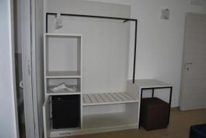 a white shelf with a tv in a room at B&B da Rosy in Lazise