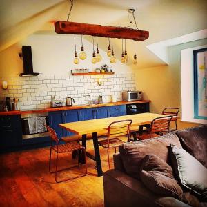 a living room with a wooden table and a couch at Bryansford Cottage Stables in Bryansford