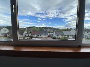 a window with a view of a residential neighborhood at Pure Apartments Fife - Dunfermline - Pitcorthie in Dunfermline