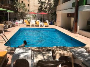a person swimming in a swimming pool at Indiana Hotel in Cairo