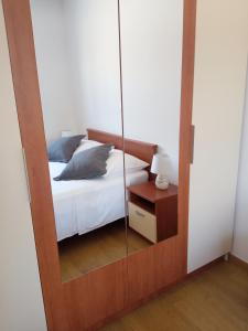 a bedroom with a mirror next to a bed at Great apartment, free parking in the garage, Žnjan in Split