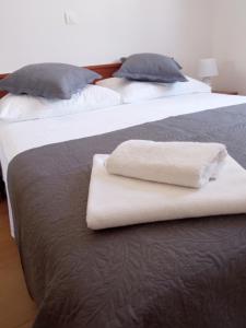 two beds with white towels sitting on top of them at Great apartment, free parking in the garage, Žnjan in Split