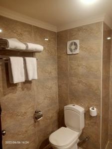 a bathroom with a toilet and towels in it at Tivoli Hotel Aqua Park in Sharm El Sheikh