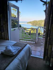 a bedroom with a bed and a view of the water at Caribbean Estates 31 Montego Bay in Port Edward