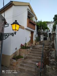 a building with stairs and a street light at ABRIGO DO CABECINHO - SERRA DA ESTRELA in Cortes do Meio