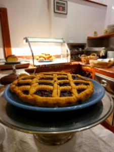 a pie on a blue plate on a table at Hotel Norden Palace in Aosta