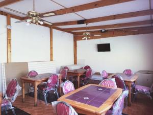 a room with tables and chairs and a tv at HOSTAL SOL ATACAMA -CALDERA in Caldera