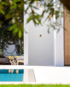 a door to a house with a pool and flowers at Le Dimore Di Speziale in Fasano