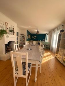 a dining room with a table and chairs and a fireplace at Villa Karllösa Bed and Breakfast in Målilla