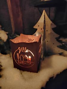 a bag of chocolate with a christmas tree behind it at Villa Karllösa Bed and Breakfast in Målilla