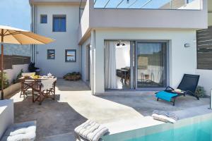 a house with a swimming pool and a patio at Villa Vagelia in  Episkopi (Chania)