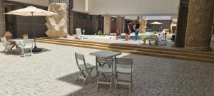 a patio with tables and chairs in a building at KechAppart KENITRA in Kenitra