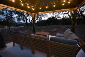 a pavilion with couches and a table and lights at Amazing Modern Farmhouse Retreat w/ 2 Suites in Canyon Lake