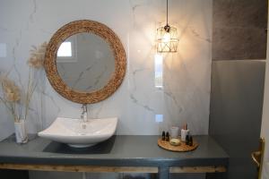 a bathroom with a sink and a mirror on a counter at Maistrali in Provatas