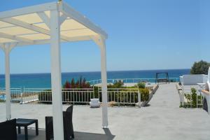 a pavilion on a beach with the ocean in the background at Maistrali in Provatas