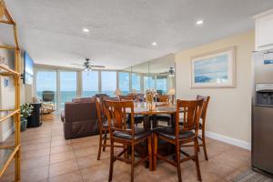 a kitchen and dining room with a table and chairs at Shores Club 703 in Daytona Beach