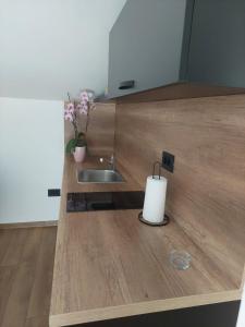 a kitchen counter with a sink and a white candle at Apartmani Naša priča in Višegrad +45 photos