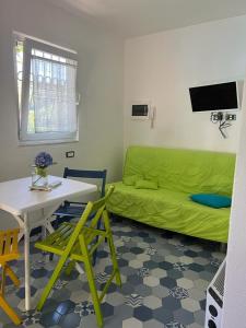 a living room with a green couch and a table at Casa Buono in Ischia