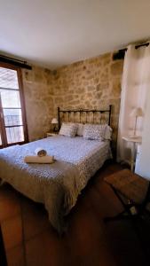 a bedroom with a bed with a tray on it at La Casa de Baix in Torre del Compte