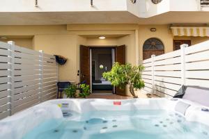 a jacuzzi tub in front of a house at Ammare rooms in Agrigento