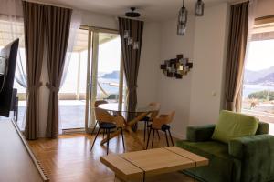 a living room with a green couch and a table at Vertmont Villa in Sveti Stefan