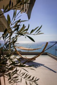 a hammock on a balcony overlooking the ocean at Vertmont Villa in Sveti Stefan