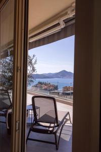 a chair sitting on a porch with a view of the ocean at Vertmont Villa in Sveti Stefan