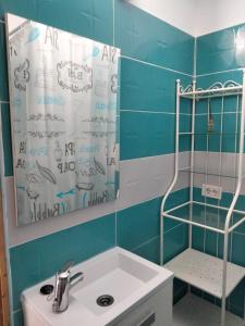 a bathroom with a sink and a shower with a mirror at Terraza Alcalá in Alcalá