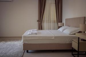 a bedroom with a large bed and a window at Vertmont Villa in Sveti Stefan