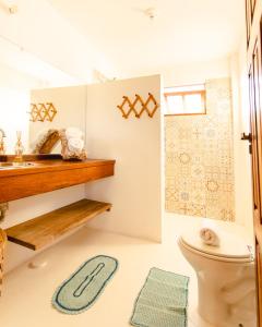 a bathroom with a toilet and a shower at Chalet du Kite in Prea