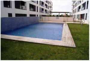 a large swimming pool in the middle of a building at Apartamento Cala Busquets 6 pax in Ciutadella