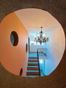 a circular staircase with a chandelier in a house at Rossa Palma in Cali