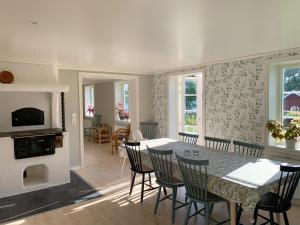 a dining room with a table and chairs and a fireplace at Holiday home Tussered Hacksvik in Håcksvik