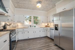 a kitchen with white cabinets and stainless steel appliances at The Wayfarer in South Haven
