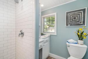 a white bathroom with a toilet and a shower at The Wayfarer in South Haven +24 photos