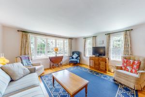 a living room with a couch and a table at Cape Charmer in Yarmouth Port