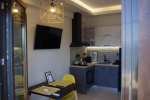 a small kitchen with a table and a dining room at Seafront Centre Ouranoupoli in Ouranoupoli +7 photos